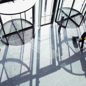 Overhead,Shot,Of,A,Businesswoman,Walking,Through,Revolving,Door,With